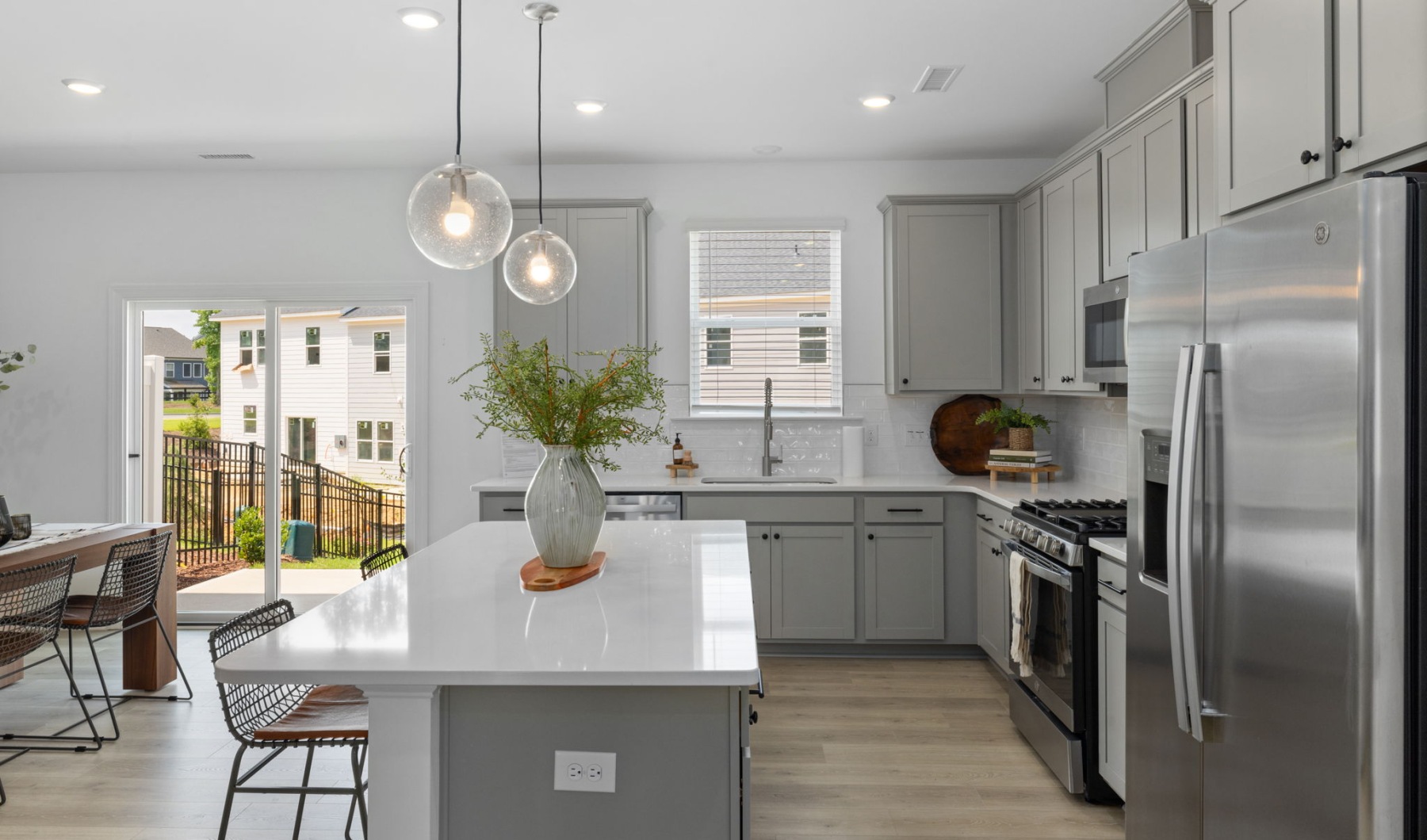 Furnished kitchen with large island and grey cabinets Furnished kitchen with large island and grey cabinets